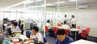 Glassed-in meeting spaces are set up in the center of the floor